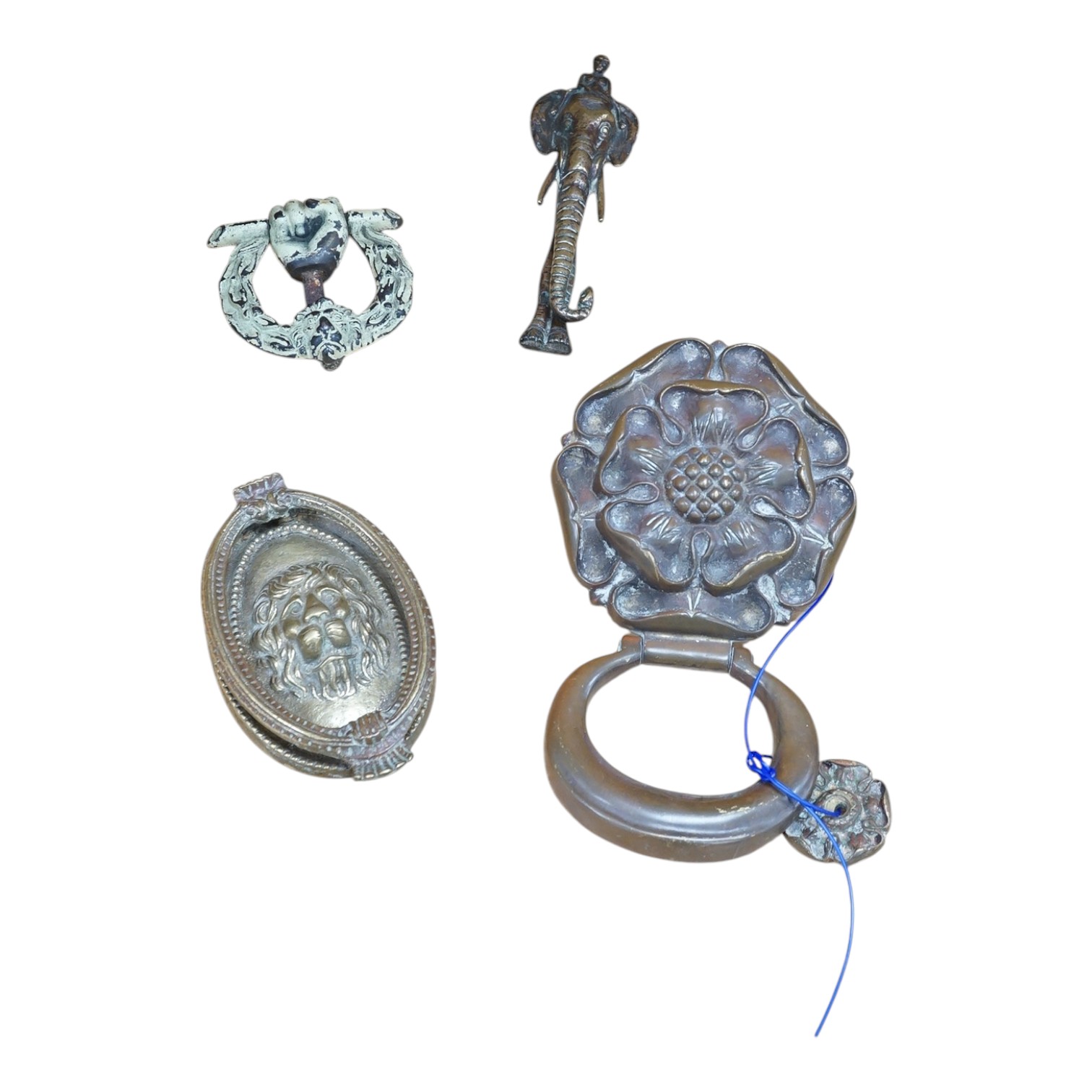 A group of four various cast brass door knockers. Condition- fair to good